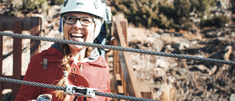 woman laughing on zipline course