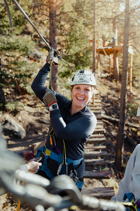 woman smiling on zipline course