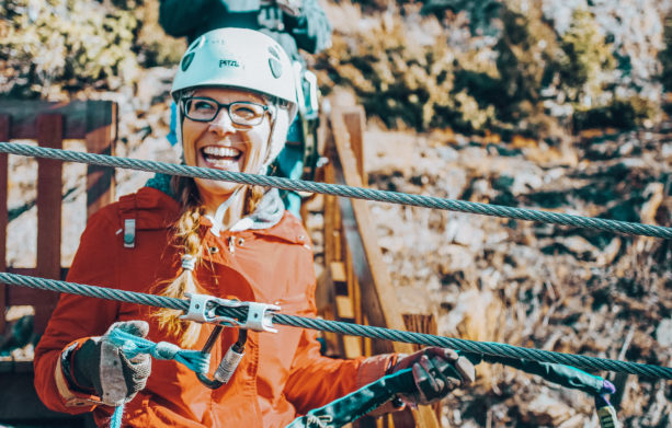 Woman smiling on a zipline course with AVA in Colorado
