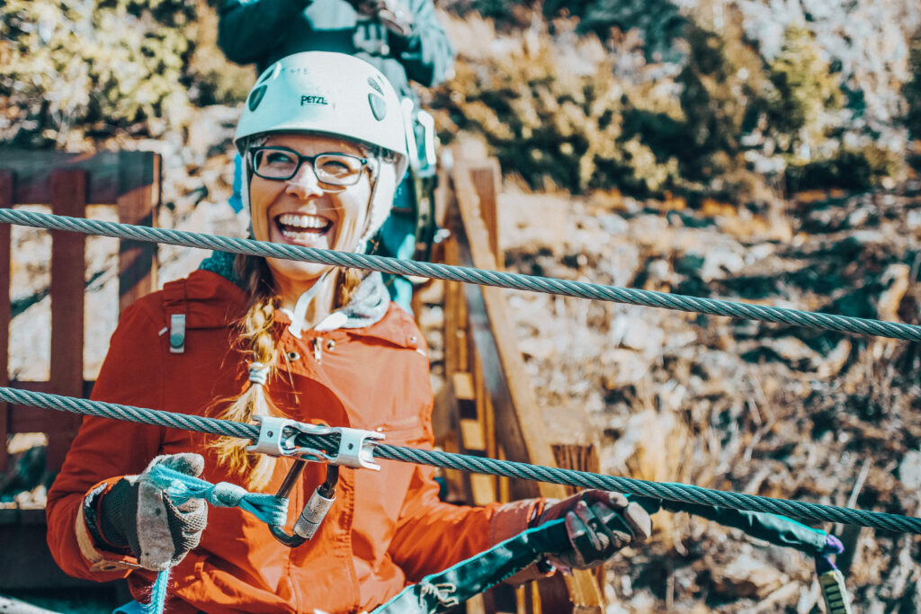 Woman smiling on a zipline course with AVA in Colorado