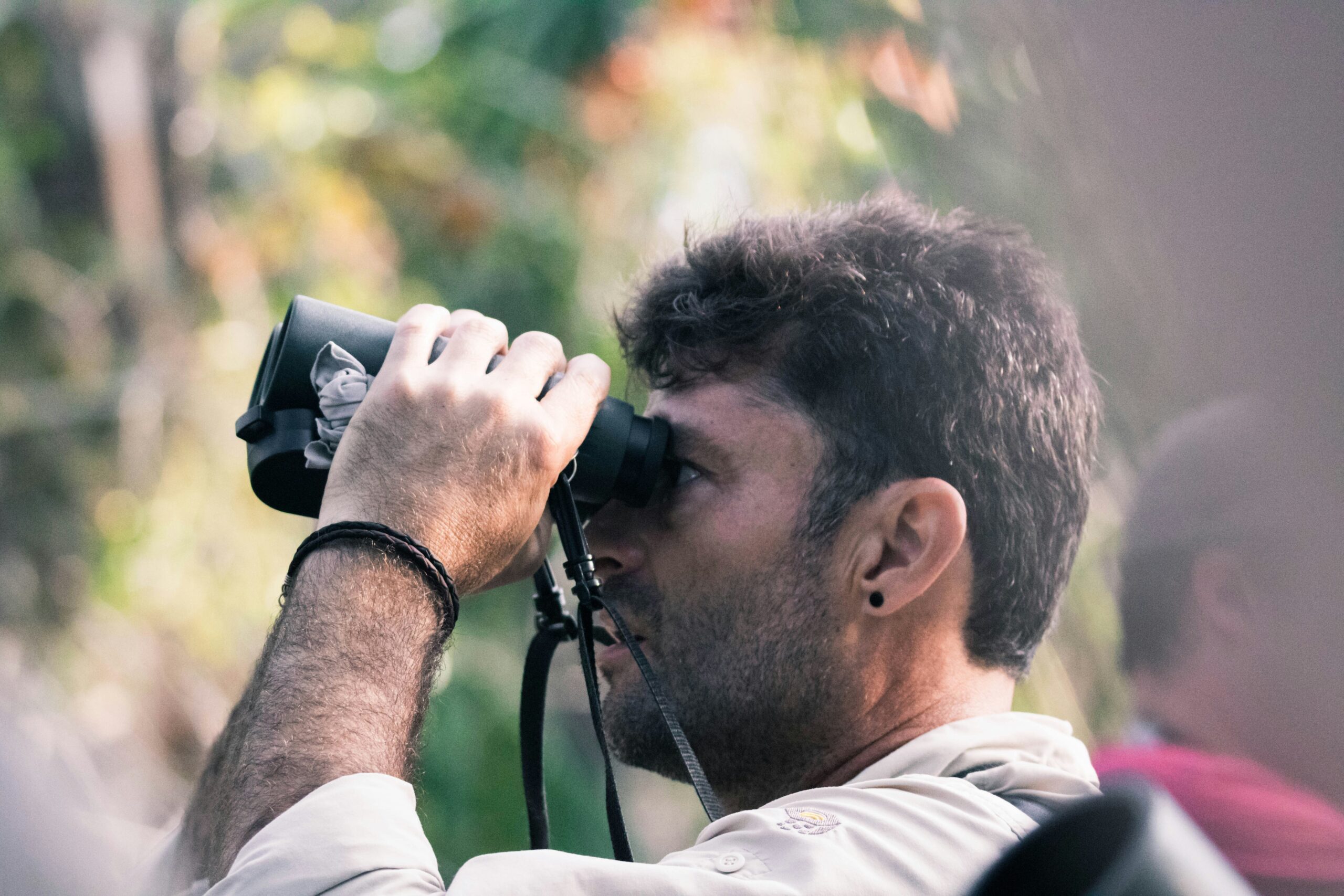 man birdwatching with binoculars